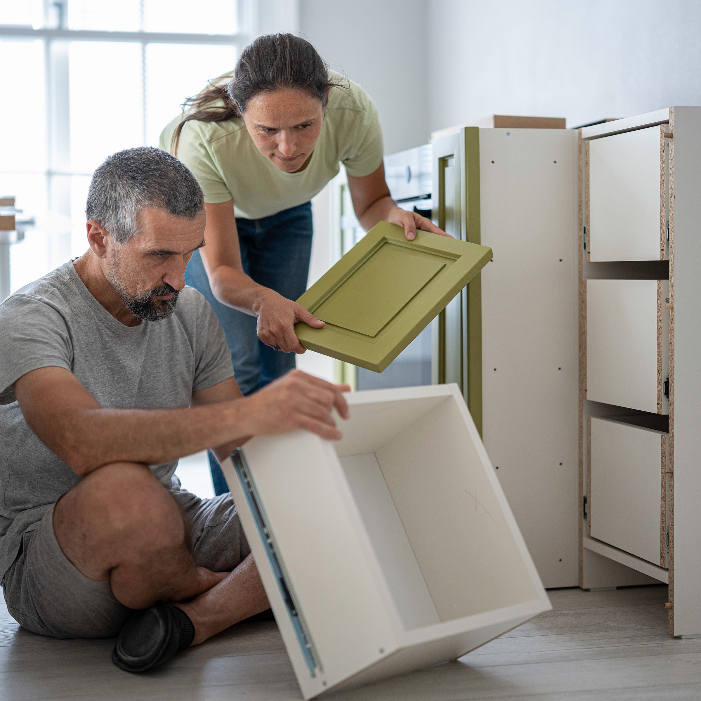 Couple working on their kitchen DIY project