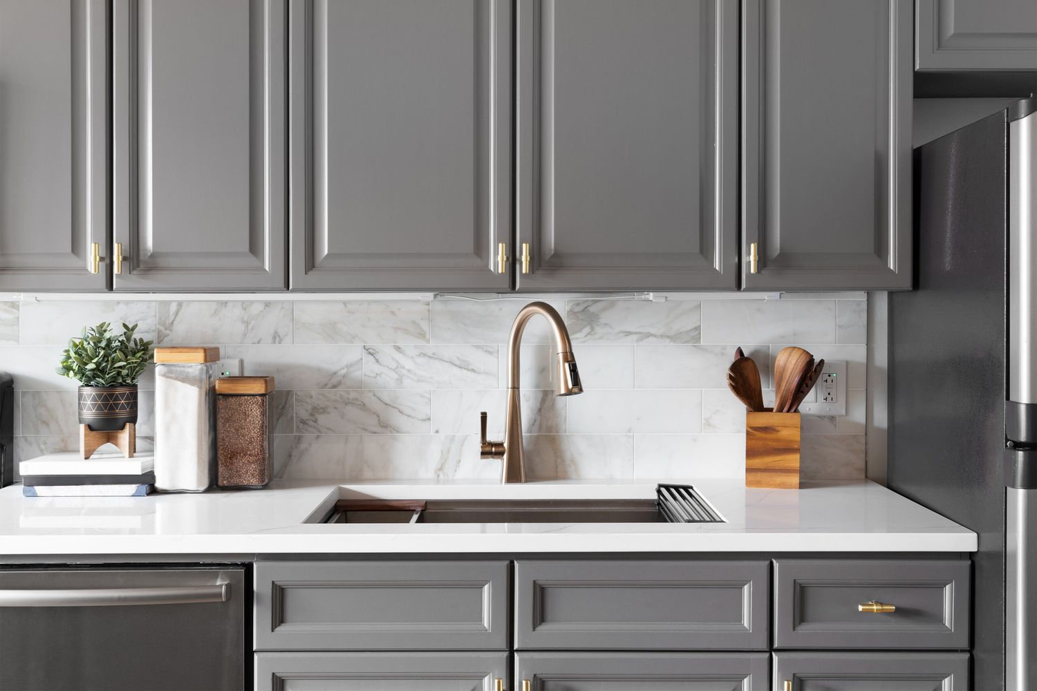 Gray kitchen cabinets around sink