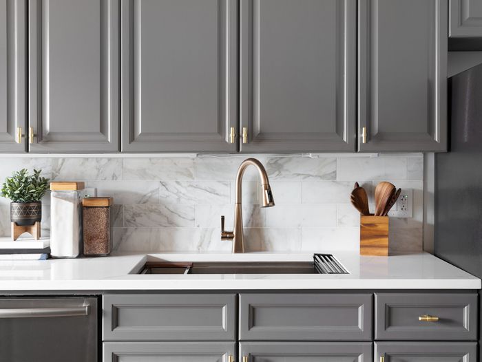 Gray kitchen cabinets around sink