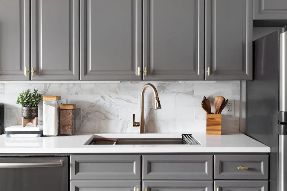 Gray kitchen cabinets around sink