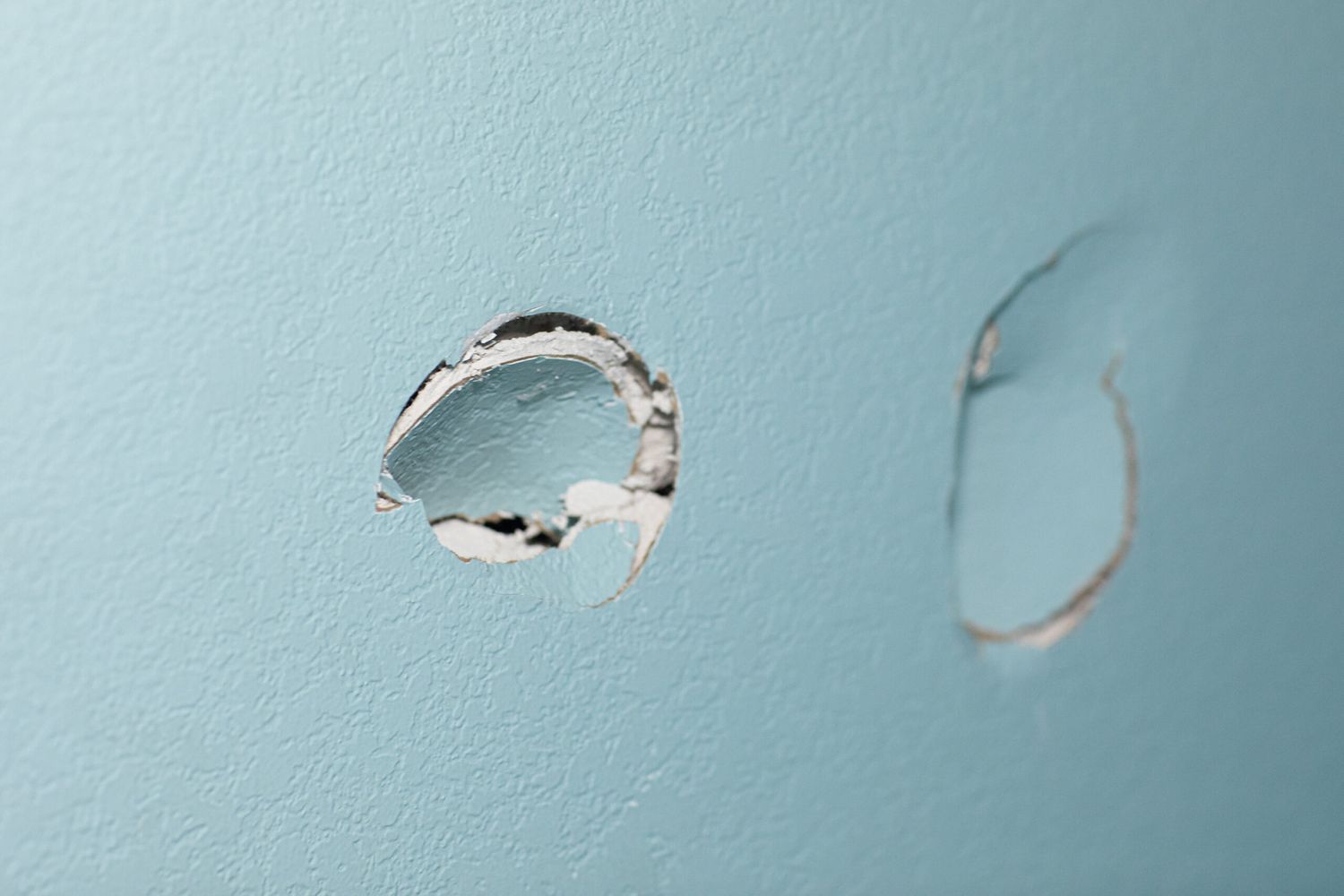 A wall with a hole in it that needs to be fixed.