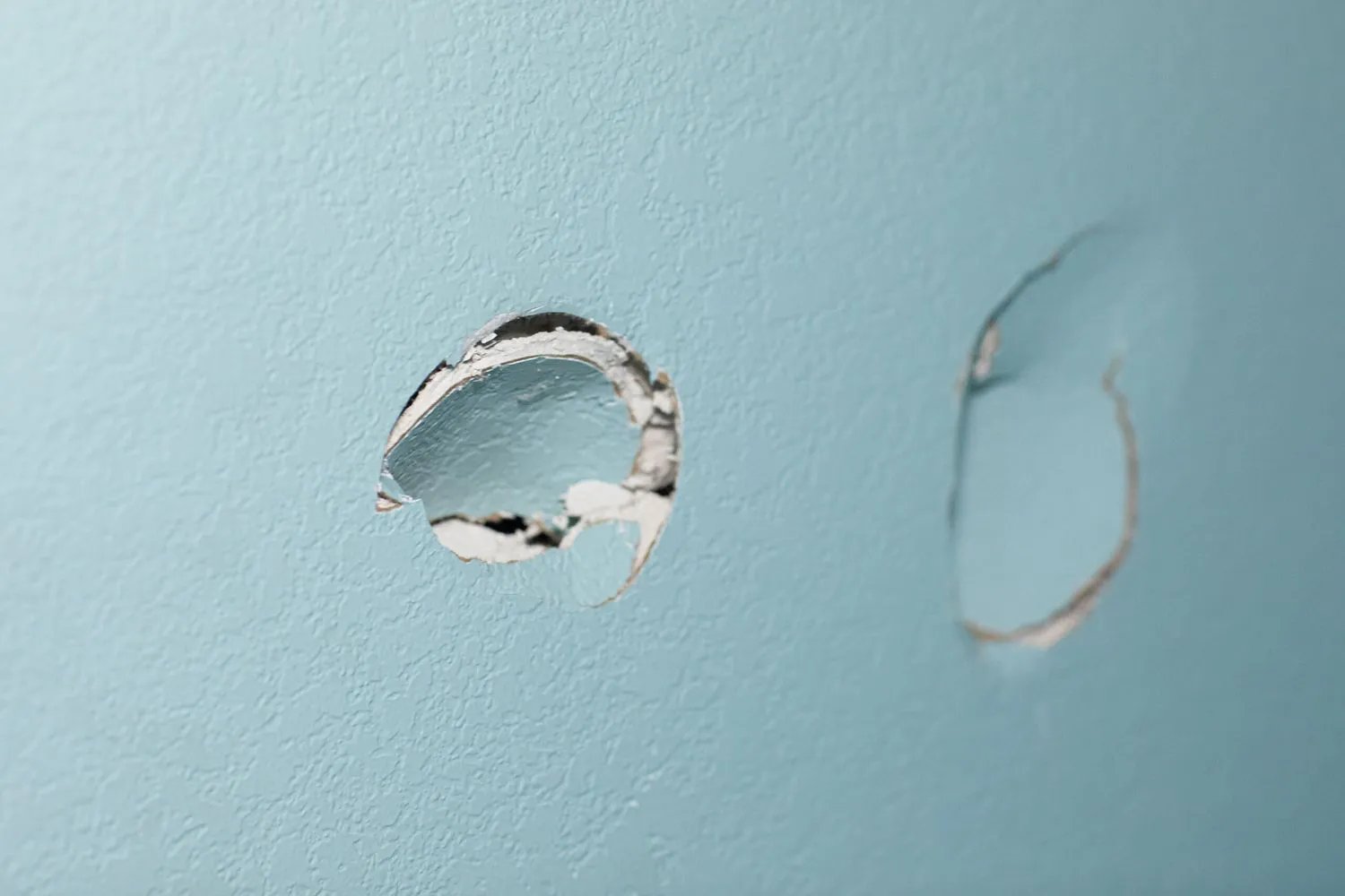 A wall with a hole in it that needs to be fixed.