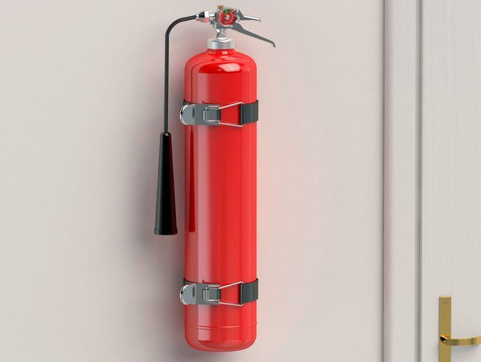 A fire extinguisher hanging on a wall.