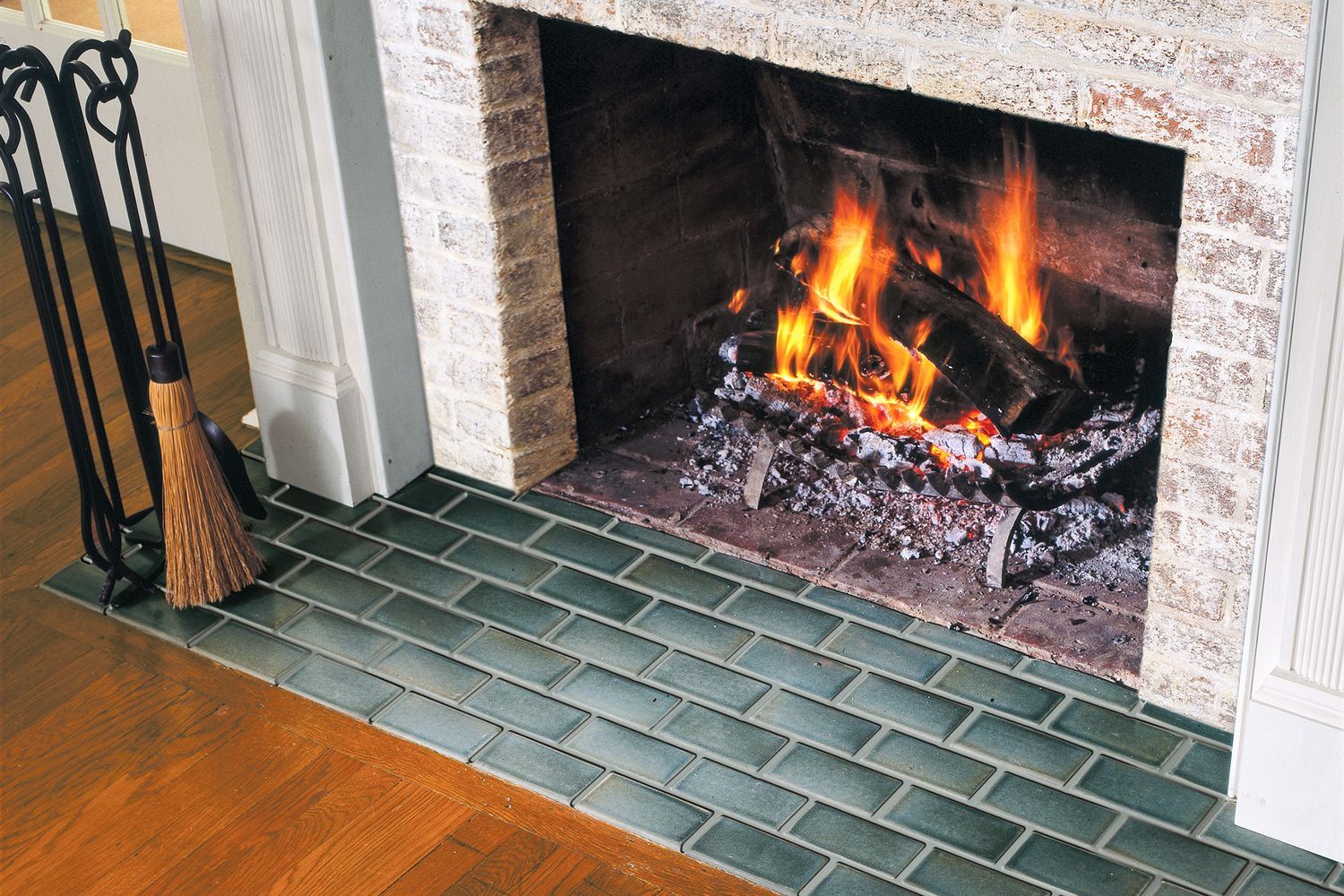 Fireplace with newly installed subway tile at the hearth