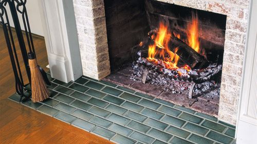Fireplace with newly installed subway tile at the hearth