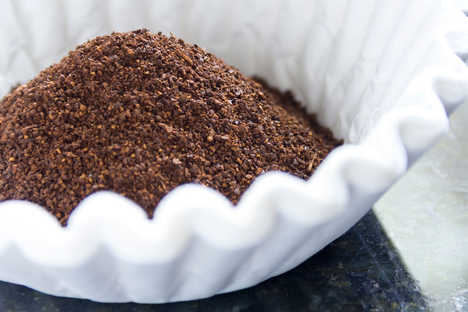 Coffee filters full of coffee grounds.
