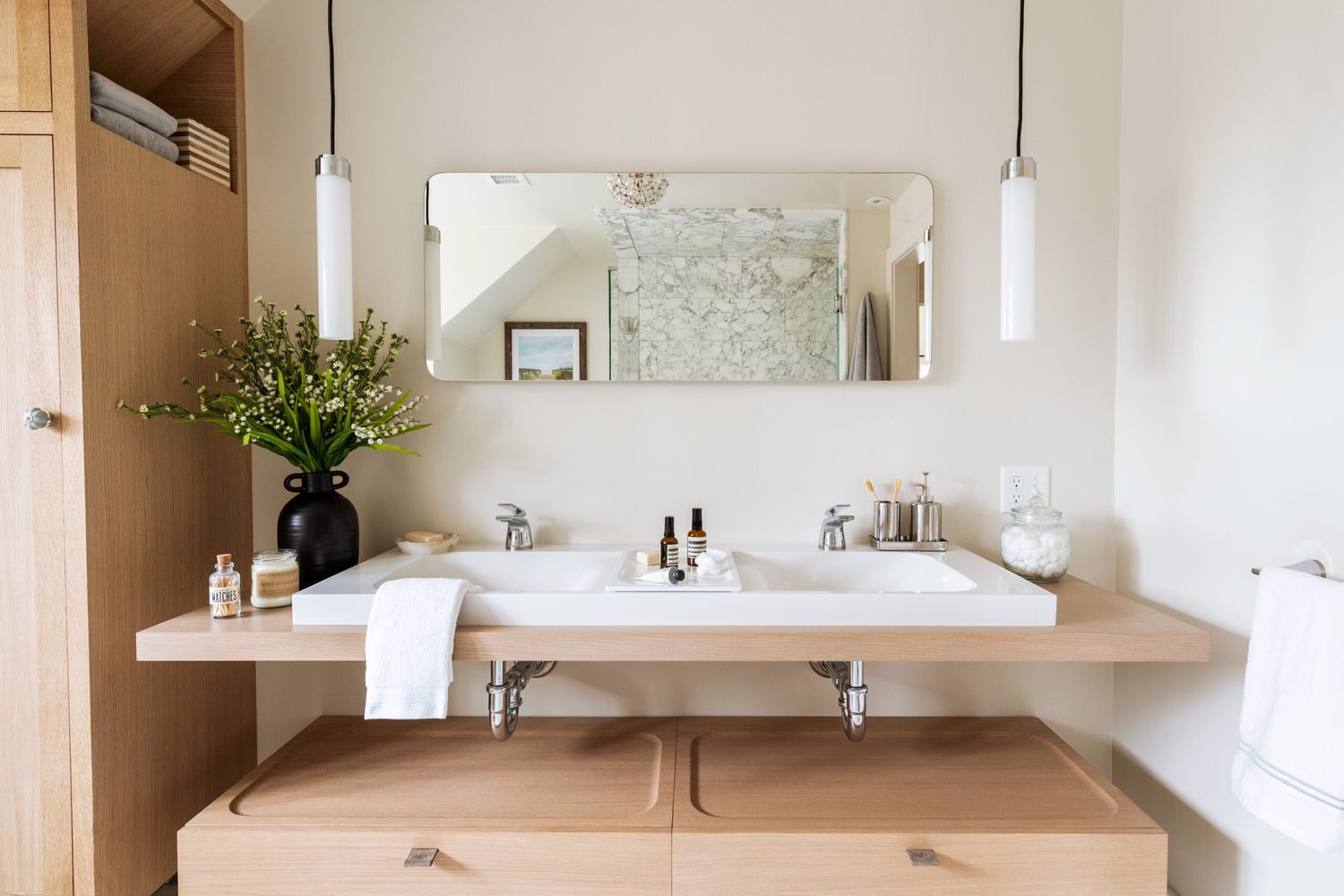 A remodeled bathroom with two sinks and a mirror.