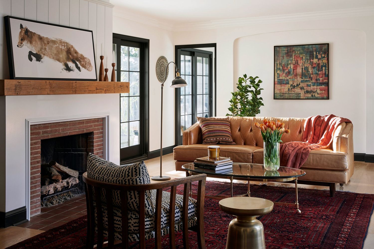 A living room with a fireplace against the wall.