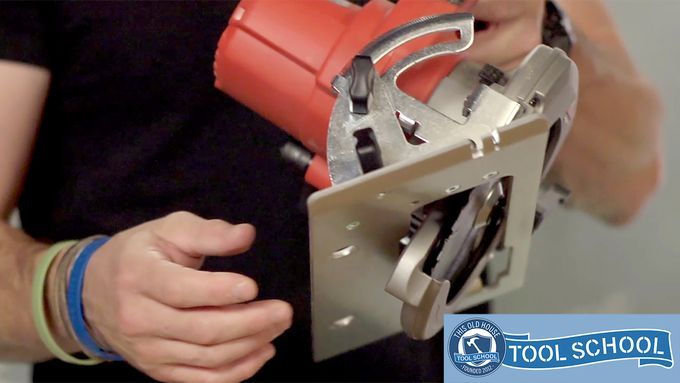 Mark Clement holding a circular saw to demonstrate its use.