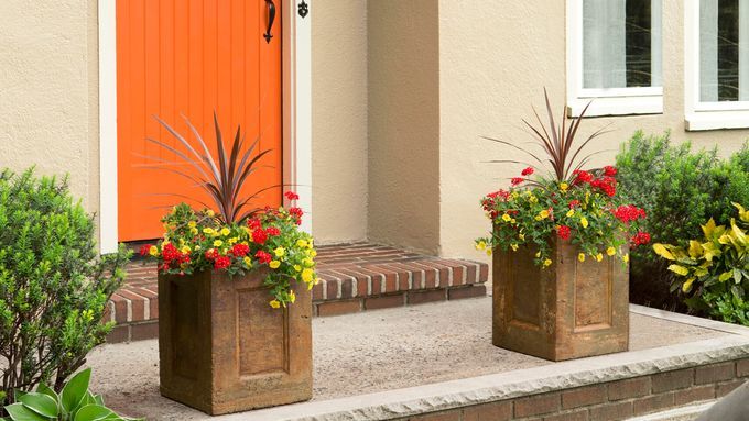 concrete planters flank a front door