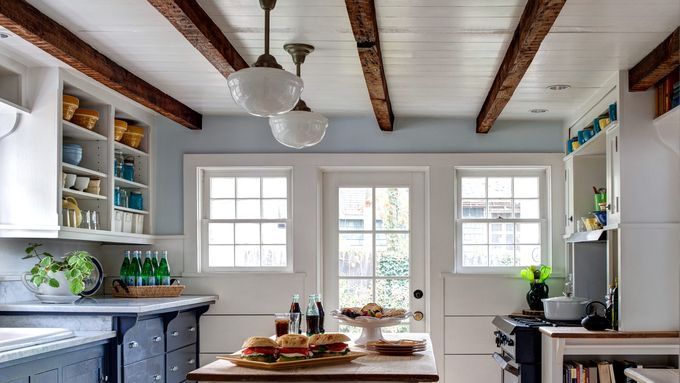 A room with faux wood beams on the ceiling.