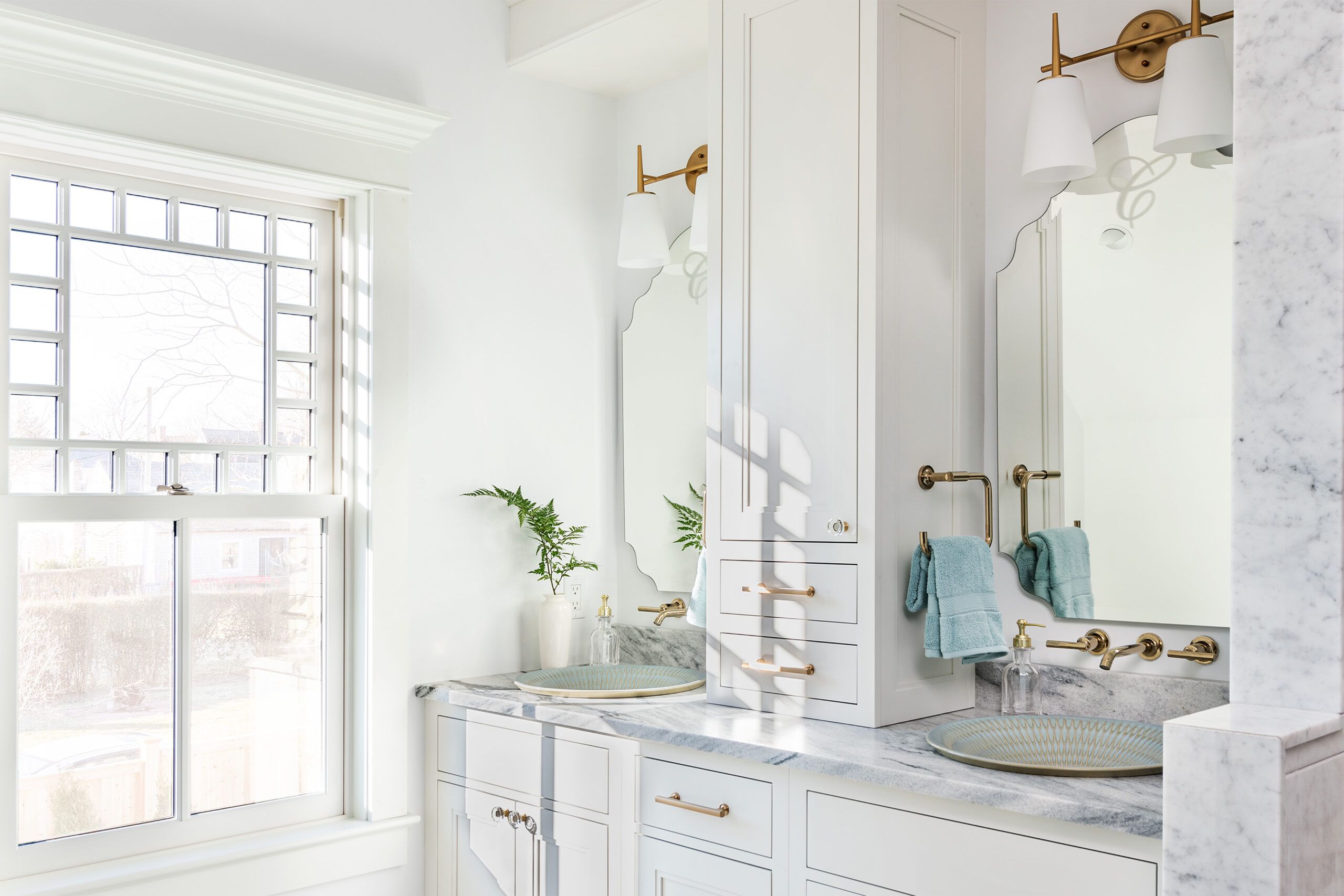 All white bathroom with gold fixtures