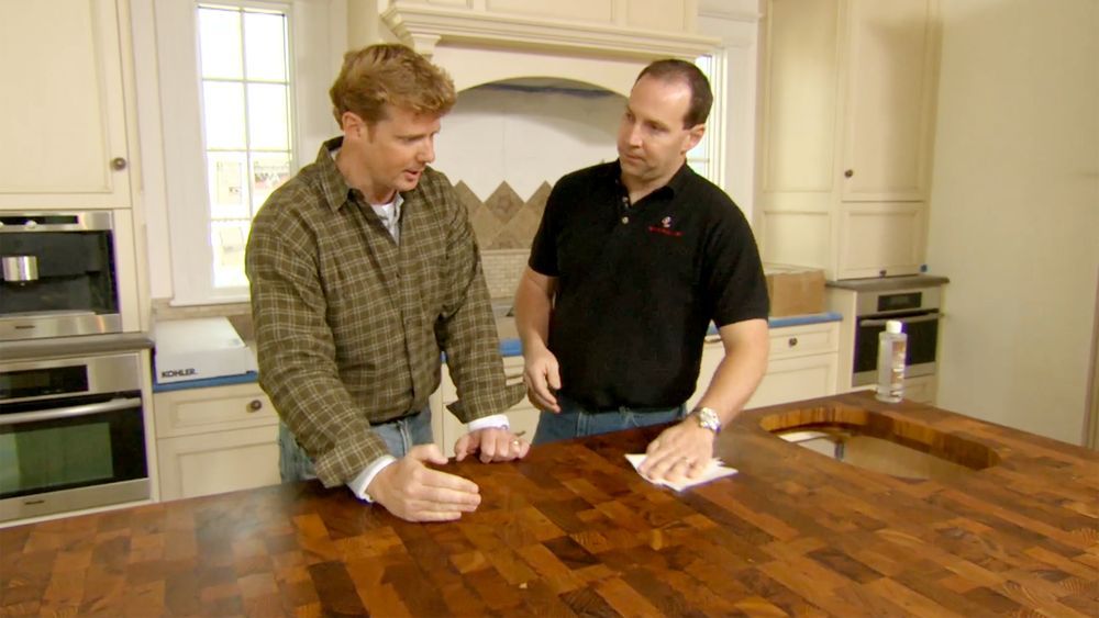 Kevin O'Connor looks at the teak island countertop at the Newton Centre House
