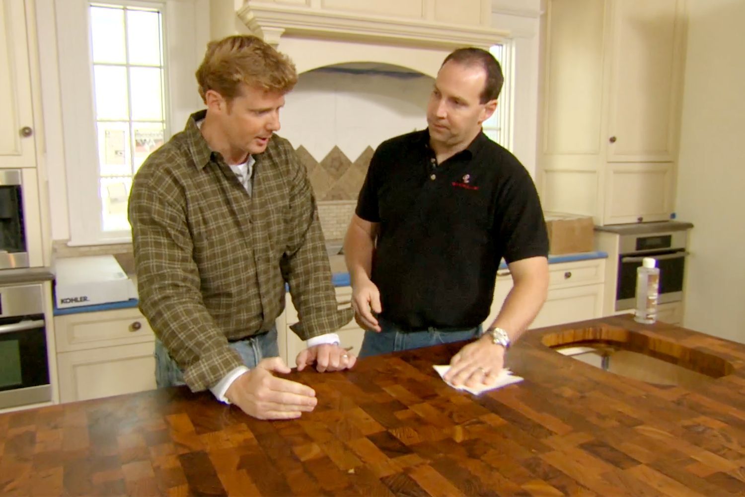 Kevin O'Connor looks at the wooden teak island countertop at the Newton Centre House