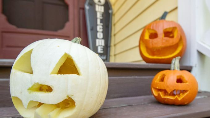 jack o lanterns sitting on the front steps leading up to a house