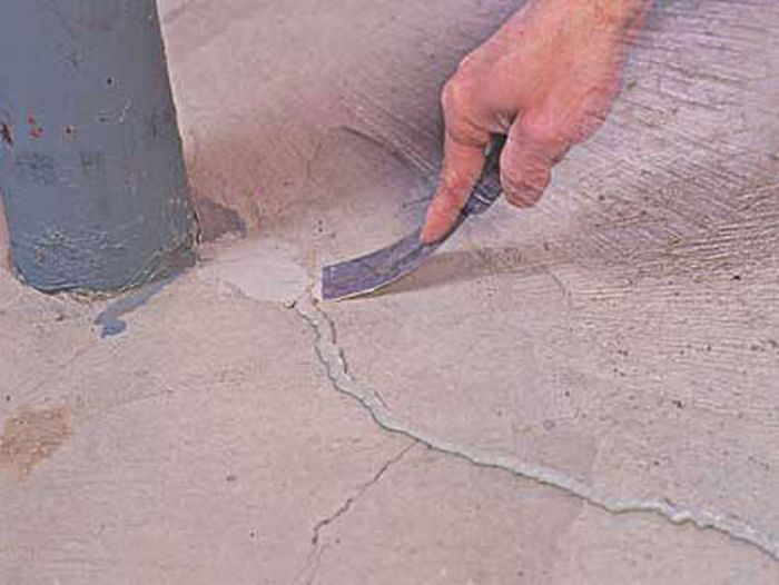 Cracked concrete is being repaired.