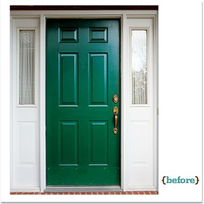 A green door sitting inside a white doorway with windows.