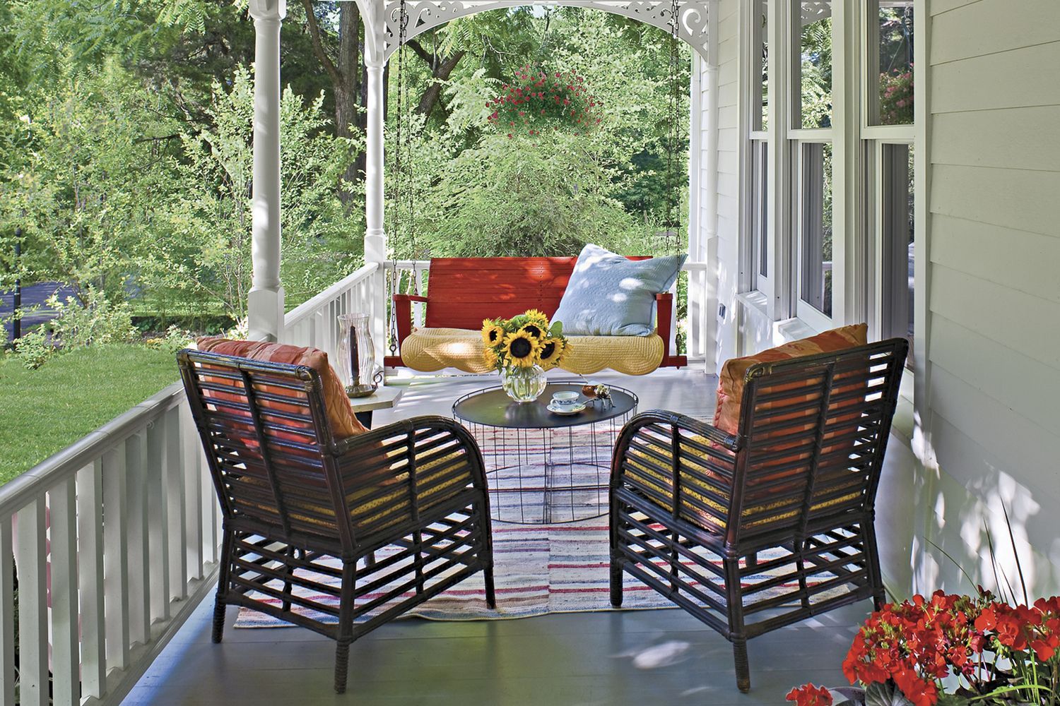 A farmhouse style porch in front of a house