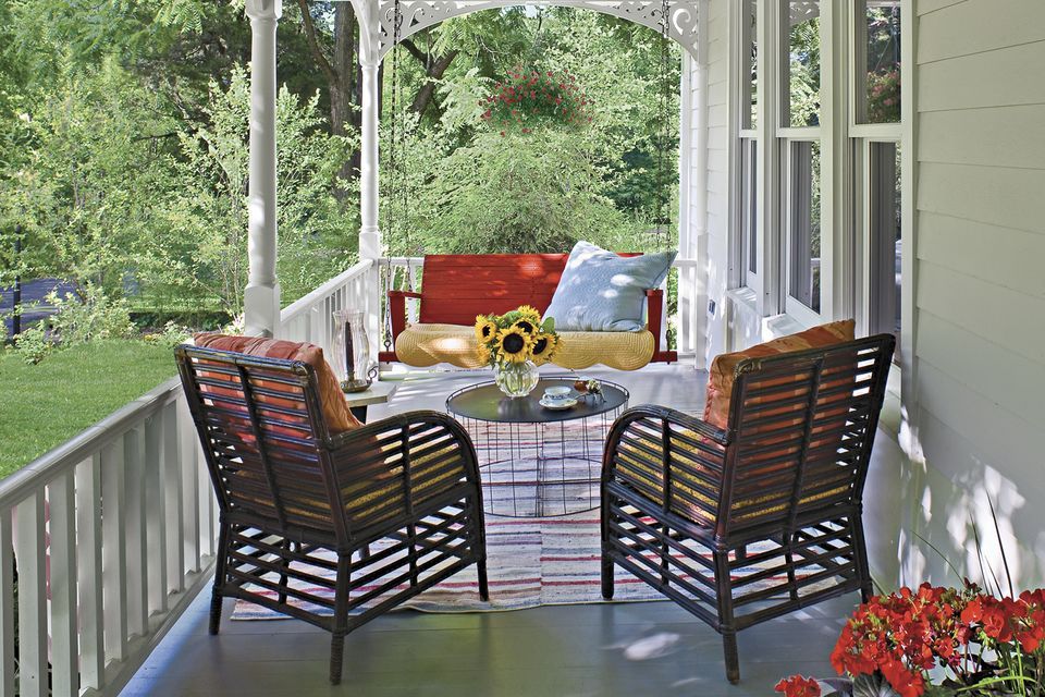 A farmhouse style porch in front of a house