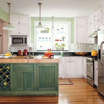 Sage green kitchen with shaker cabinets in a renovated 1880s house