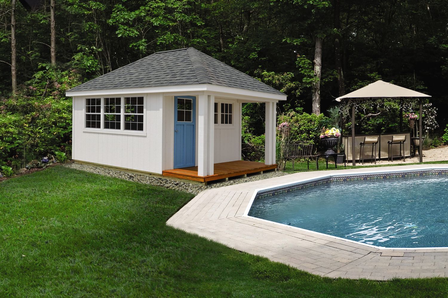 A shed sitting next to a pool.