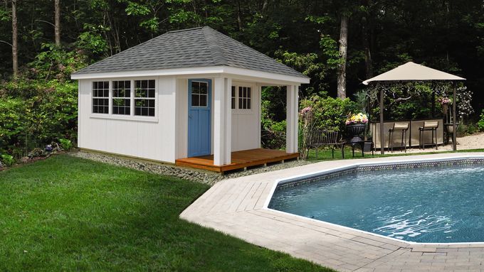 A shed sitting next to a pool.