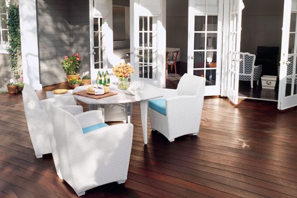 A hardwood deck with chairs and a table.