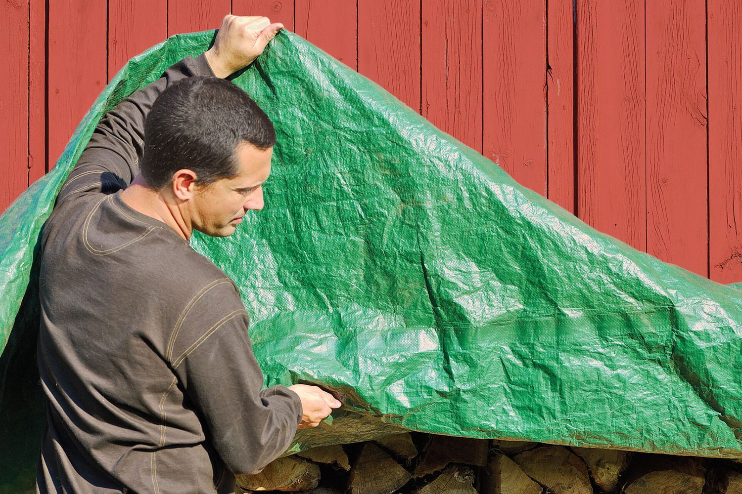 a man lifting a tarp