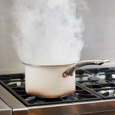 a pot on a stove starting to smoke