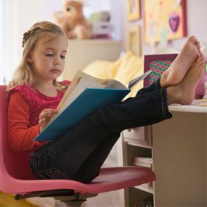 A young girl reading in a study space.