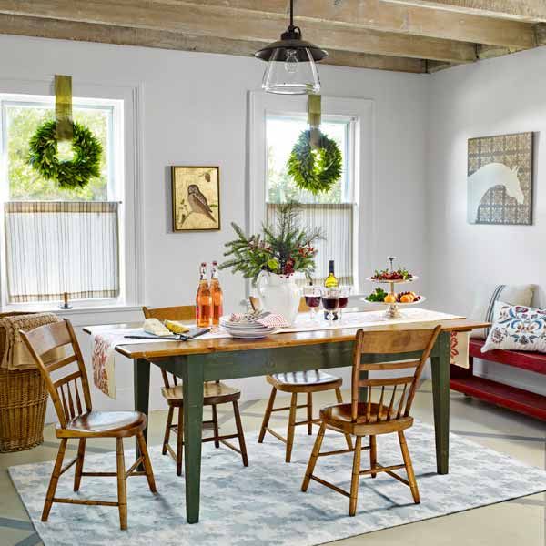 A dining room table with 4 seats and food on top of it.