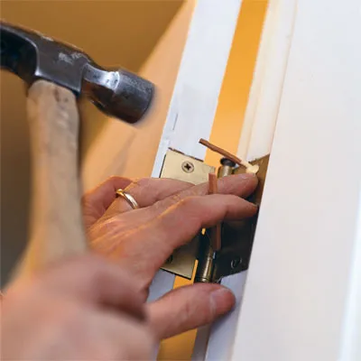 Tom Silva fixes a loose hinge on a stinking door.