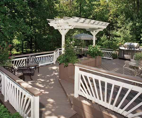 A stained wood deck with multiple levels and a built-in planter bench.