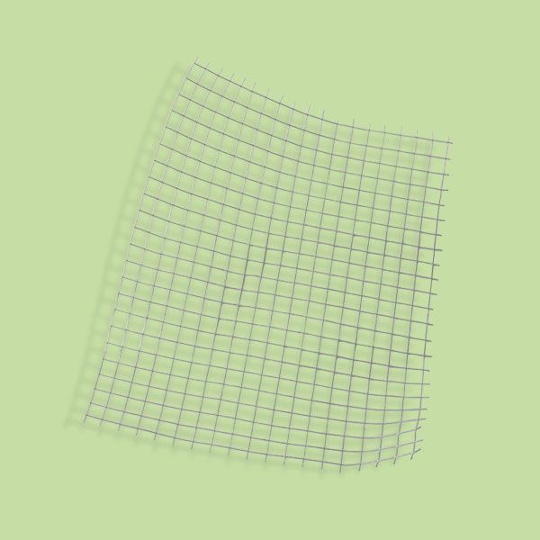 A piece of hardware cloth in front of a light green background.