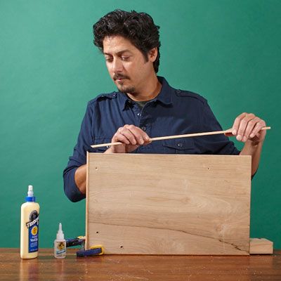 A man prepares to build a log holder.