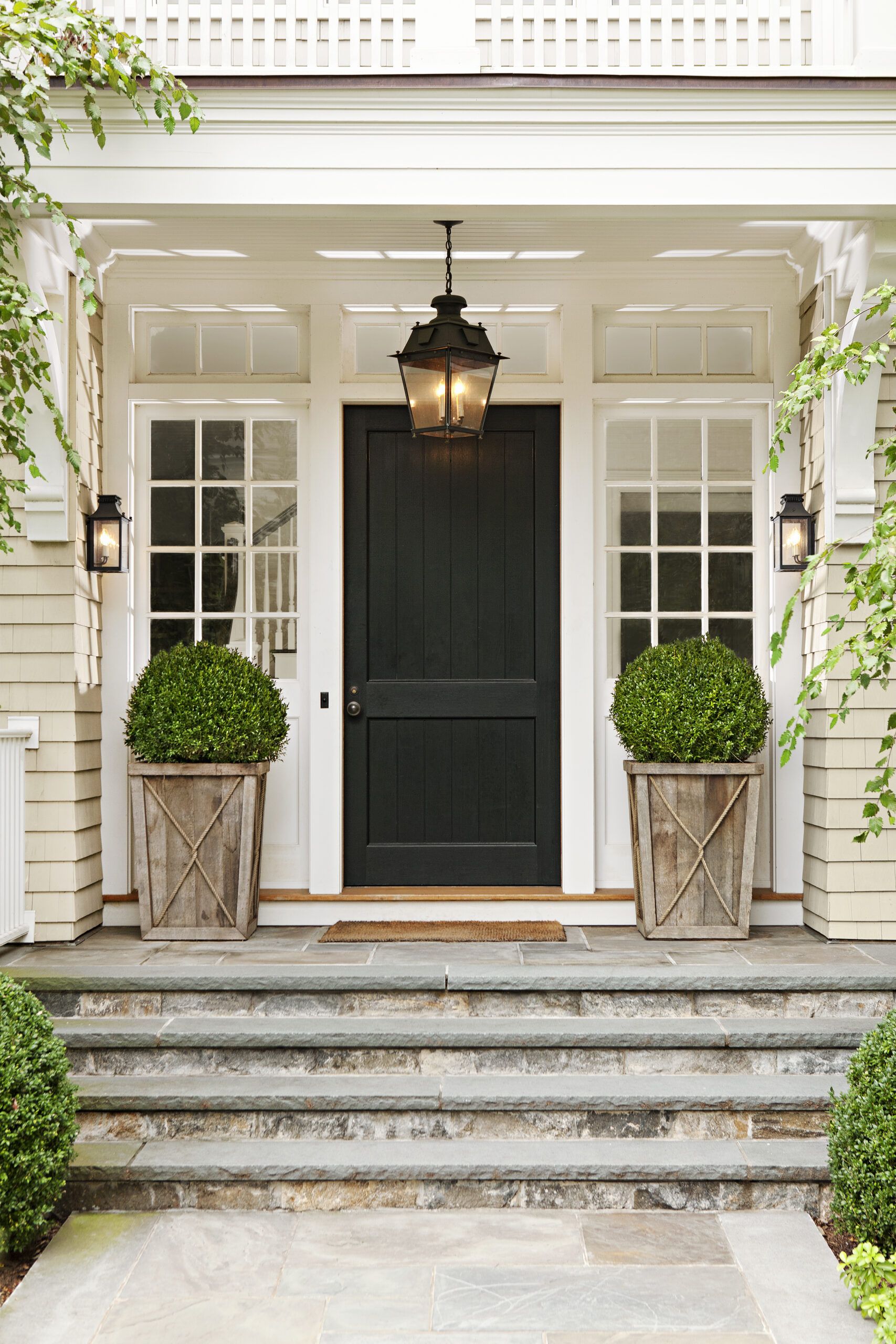 Black front door on a white house.