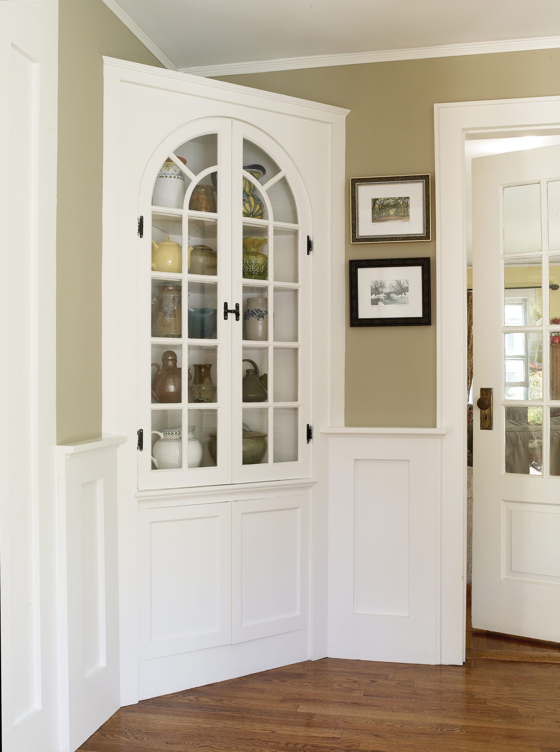 A corner hutch storage unit in a hallway.