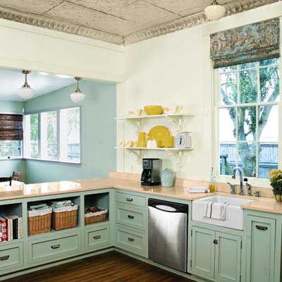 Sage green kitchen with shaker cabinets in a renovated 1880s house