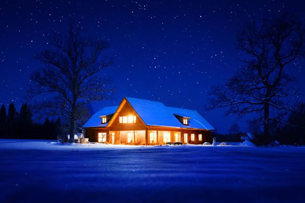 A home that is lit up as a security measure in winter.