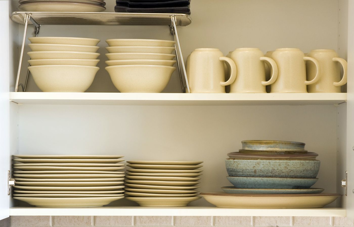 Open kitchen shelves with plates, bowls, and cups.