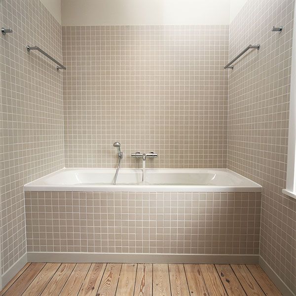 Image of grab bars in a bathroom tub, which are useful in a bathroom where slips and falls are likely to occur