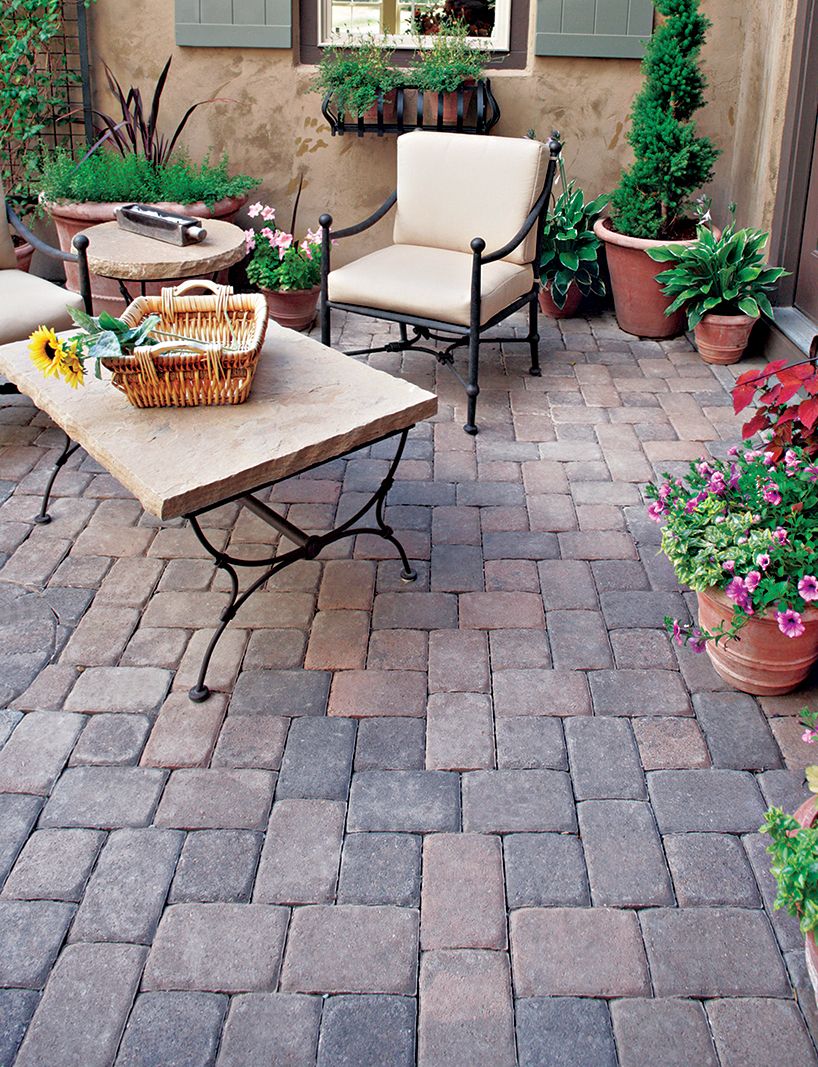 A backyard patio built with concrete pavers.