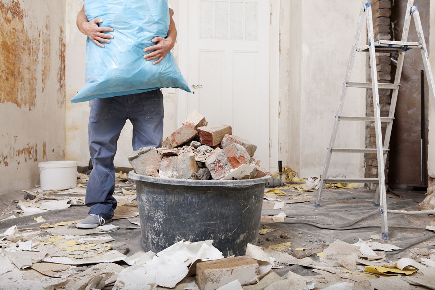 Waste being piled up and removed from a room.