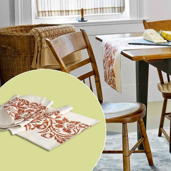 A block print runner stretched across a dining room table.