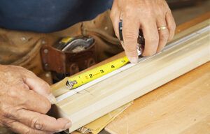 Two images of a man working on constructing a spindle headboard.