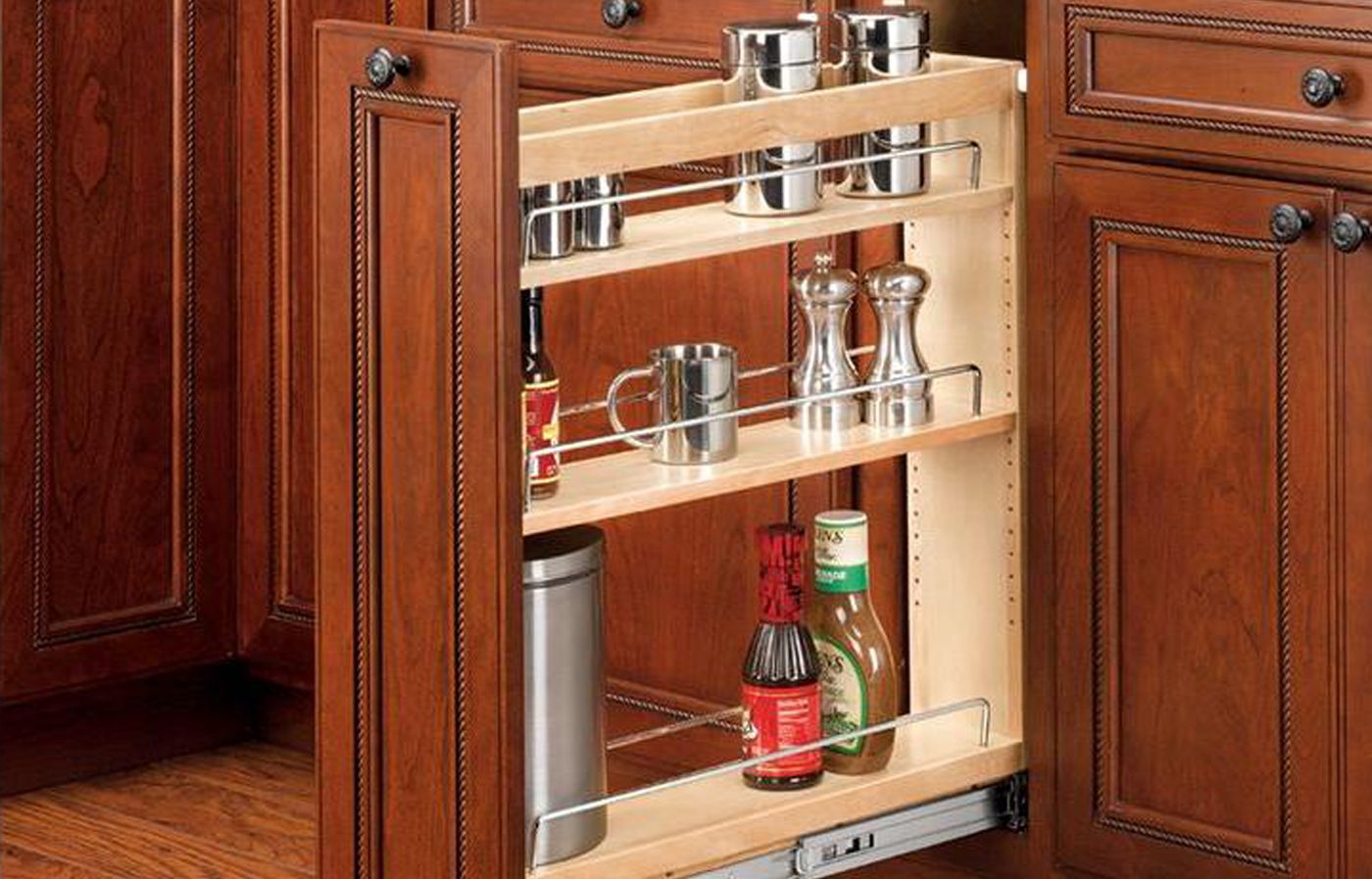 Image of a narrow spice rack that slides between cabinets, which is a great way to hide kitchen clutter