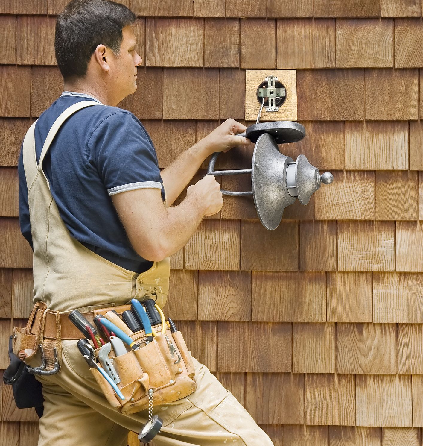 image of a professional electrician installing front entry lighting