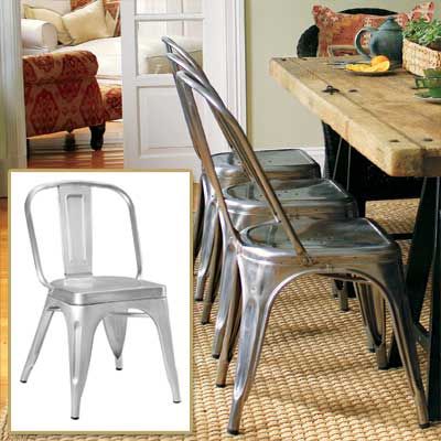 Image of industrial chairs, used to create a contemporary edge in a rustic french dining room