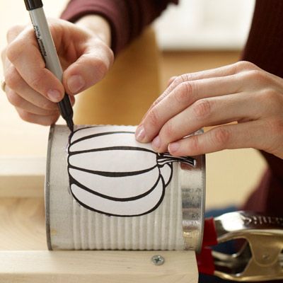 drawing designs on the tin cans