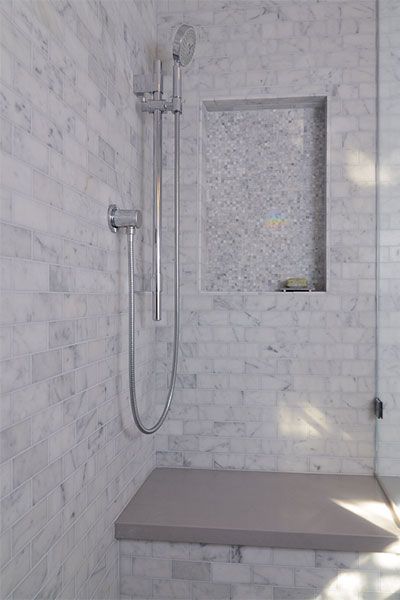 Image of a handheld shower head in a shower, which is a great functional addition to a bathroom